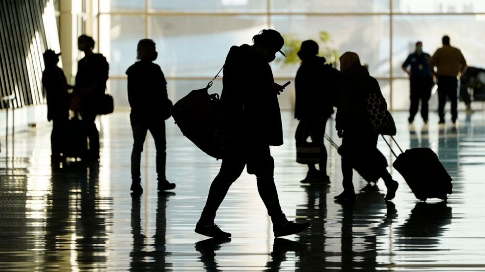 FILE - Passengers walk through Salt Lake City International Airport in Salt Lake City, Oct. 27, 2020. More than a year and a half after COVID-19 concerns prompted the U.S. to close its borders to international travelers from countries including Brazi