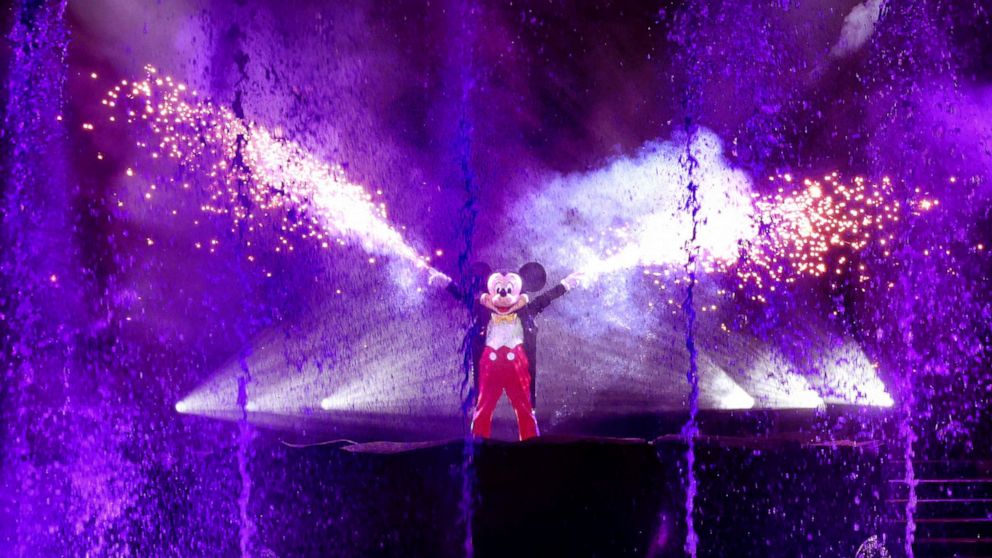 Mickey Mouse fires his fan-favorite hand sparklers during the first night of 'Fantasmic' returning to Disney's Hollywood Studios, Thursday, Nov. 3, 2022, in Lake Buena Vista, Fla. The elaborate pyrotechnics, lasers, fountains and water-screen spectac