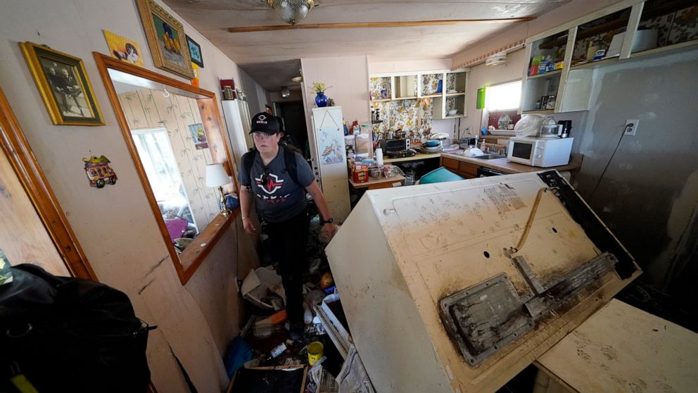 Members of mediccorps.org search a home in Pine Island, Fla., whose resident was known to have stayed behind when Hurricane Ian bore down on Florida but has not been heard from since, Saturday, Oct. 1, 2022. Paramedics and volunteers with mediccorps.