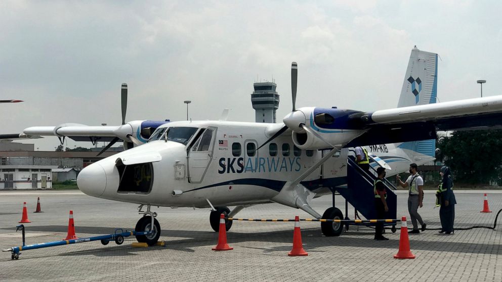 Grand staff prepare for the first flight of Twin Otter aircraft after a launching ceremony at Subang terminal in Kuala Lumpur, Malaysia, Tuesday, Jan. 25, 2022. New low-cost Malaysian carrier, SKS Airways, took to the skies Tuesday with short-haul fl