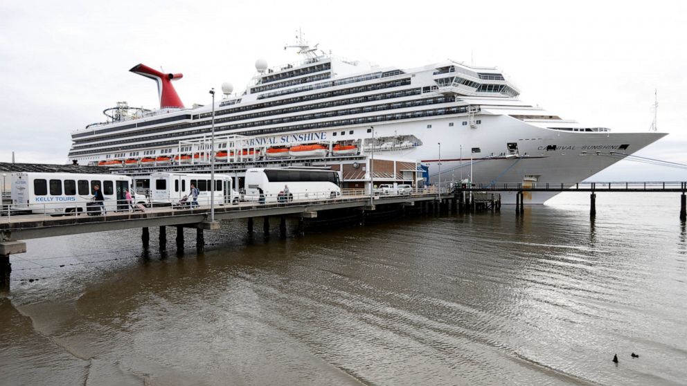 FILE -Passengers disembark from the Carnival Sunshine cruise ship Monday, March 16, 2020, in Charleston, S.C. Federal officials are dropping a health warning that they have attached to sailing on cruise ships since the start of the pandemic. The U.S.