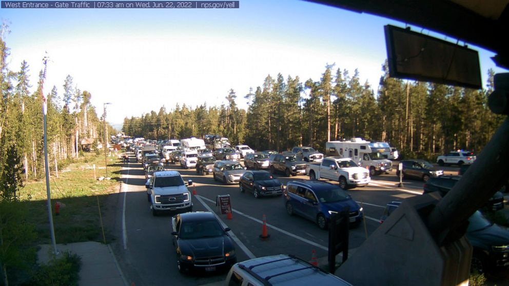 This photo provided by National Park Service shows West Entrance gate traffic on Wednesday, June 22, 2022 at Yellowstone National Park in Montana. Visitors will return to a changed landscape in Yellowstone National Park on Wednesday as it partially r
