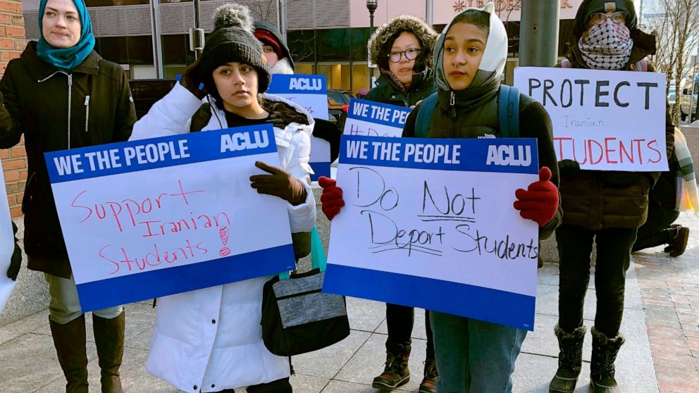 Protesters stand outside the federal courthouse where a hearing was scheduled for Northeastern University student Shahab Dehghani, Tuesday, Jan. 21, 2020, in Boston. Dehghani arrived on a flight into Boston on Monday but was detained by U.S. Customs 
