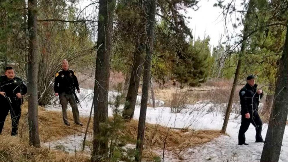 In this photo provided by the Gallatin County Sheriff's Office, officers from the sheriff's office and West Yellowstone Police Department are seen near the scene of a grizzly bear mauling just outside Yellowstone National Park near West Yellowstone, 