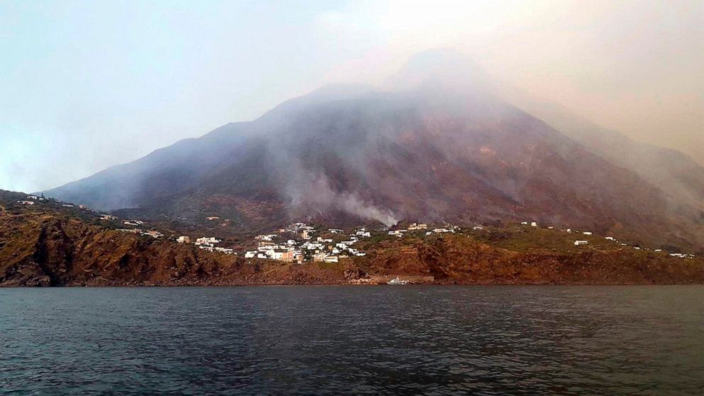 Smoke billows from the volcano on the Italian island of Stromboli, Wednesday, July 3, 2019. The news agency ANSA says that some 30 tourists jumped into the sea out of fear after a series of volcano erupted on the Sicilian island of Stromboli. Civil p