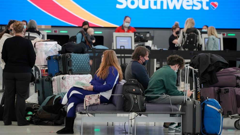 Travelers check in at the Southwest Airlines counter as the Thanksgiving Day holiday approaches Tuesday, Nov. 23, 2021, at Denver International Airport in Denver. Southwest Airlines says travel was strong over Thanksgiving and that momentum is carryi