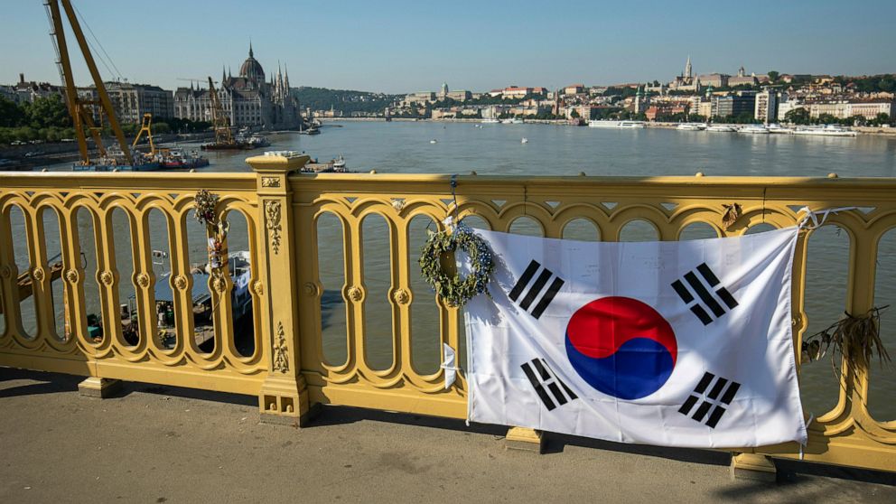 A Korean flag adorns the rail of Margaret Bridge, the scene of the deadly boat accident in Budapest, Hungary, Saturday, June 8, 2019. A sightseeing boat carrying 33 South Korean tourists was crashed by a large river cruise ship and sank in the River 