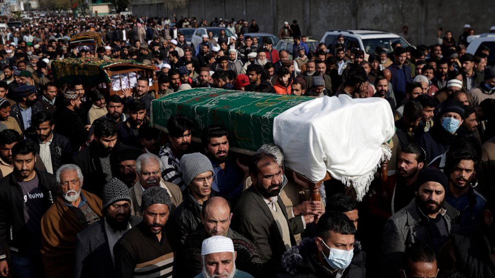 People carry six bodies from one family that were killed after being stuck in their vehicles overnight during a heavy snowstorm as temperatures plummeted, in the area of the Murree Hills resort, in Rawalpindi, adjacent to Pakistan's capital of Islama