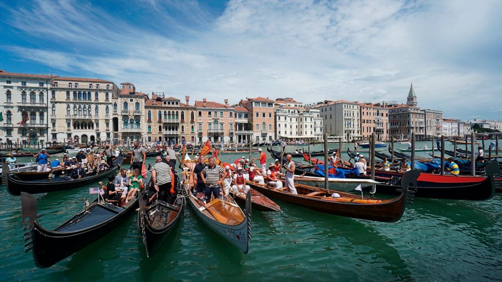 FILE - In this Sunday, June 21, 2020 file photo, gondolas are lined up during the Vogada della Rinascita (Rowing of Rebirth) regatta, along Venice canals, Italy. European Union envoys are close to finalizing a list of countries whose citizens will be