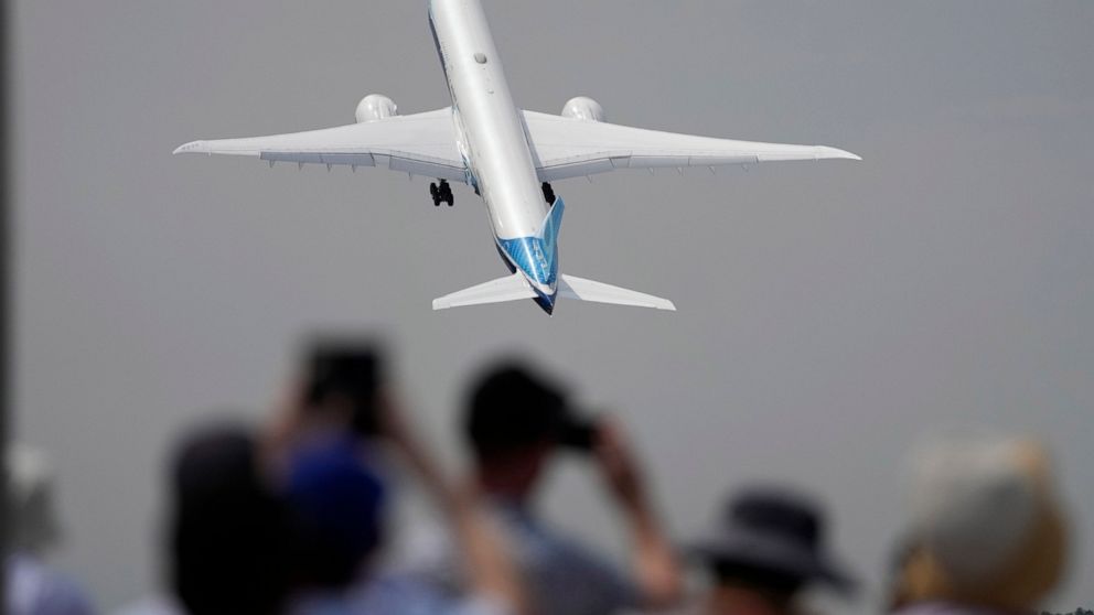 A Boing 777X plane takes off at the Farnborough Air Show fair in Farnborough, England, Monday, July 18, 2022. Some 1200 exhibitors from around the world will show their newest developments in Future Flight, Space, Defence, Innovation, Sustainability 