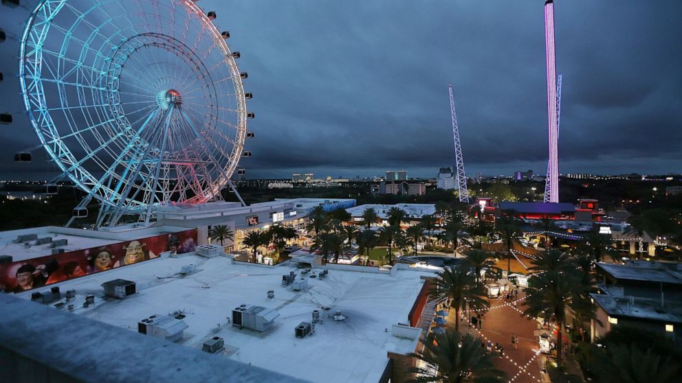 ICON Park attractions, The Wheel, left, Orlando SlingShot, middle, and Orlando FreeFall, right, are shown in Orlando, Fla., on Thursday, March 24, 2022. A 14-year-old boy fell to his death from a ride at an amusement park in Orlando, sheriff's offici