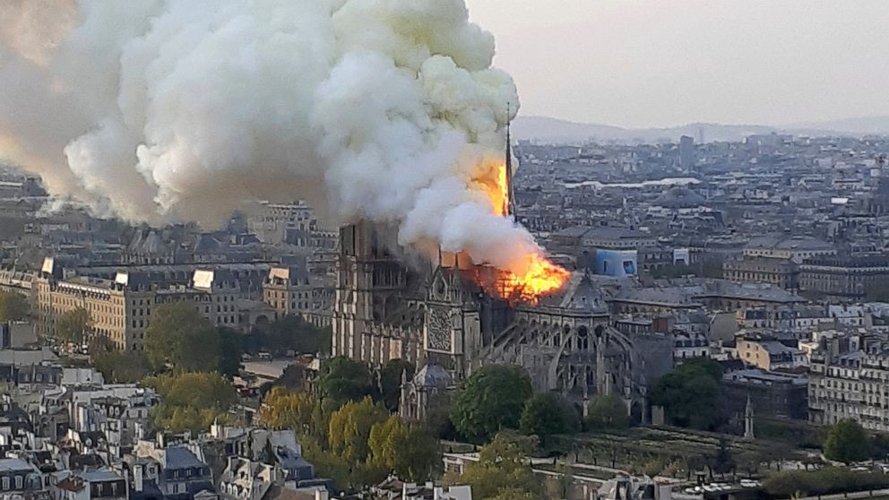 In this image made available on Tuesday April 16, 2019 flames and smoke rise from the blaze at Notre Dame cathedral in Paris, Monday, April 15, 2019. An inferno that raged through Notre Dame Cathedral for more than 12 hours destroyed its spire and it