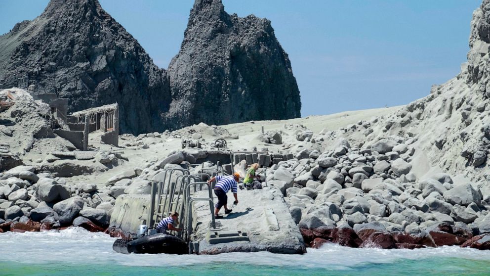In this Dec. 9, 2019, photo provided by Michael Schade, rescuers land on White Island following the eruption of the volcano on White Island, New Zealand. Unstable conditions continued to hamper rescue workers from searching for people missing and fea