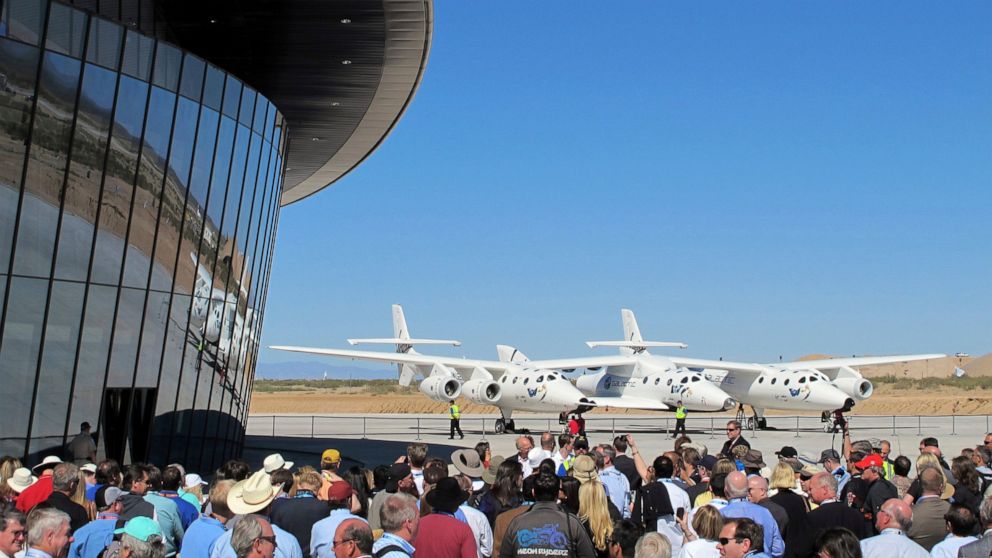 FILE - In this Oct. 17, 2011, file photo a crowd gathers outside Spaceport America for a dedication ceremony as Virgin Galactic's mothership WhiteKnightTwo sits on the tarmac near Upham, N.M. British billionaire Richard Branson is taking another conc