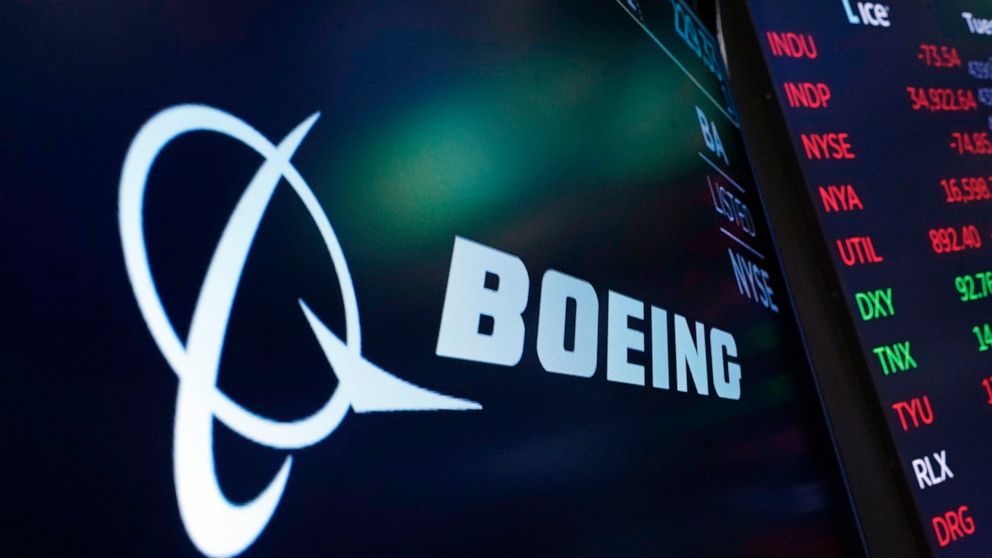 FILE - The logo for Boeing appears on a screen above a trading post on the floor of the New York Stock Exchange, Tuesday, July 13, 2021. Boeing reported a $3.3 billion loss for the third quarter Wednesday, Oct. 26, 2022, as revenue fell short of expe
