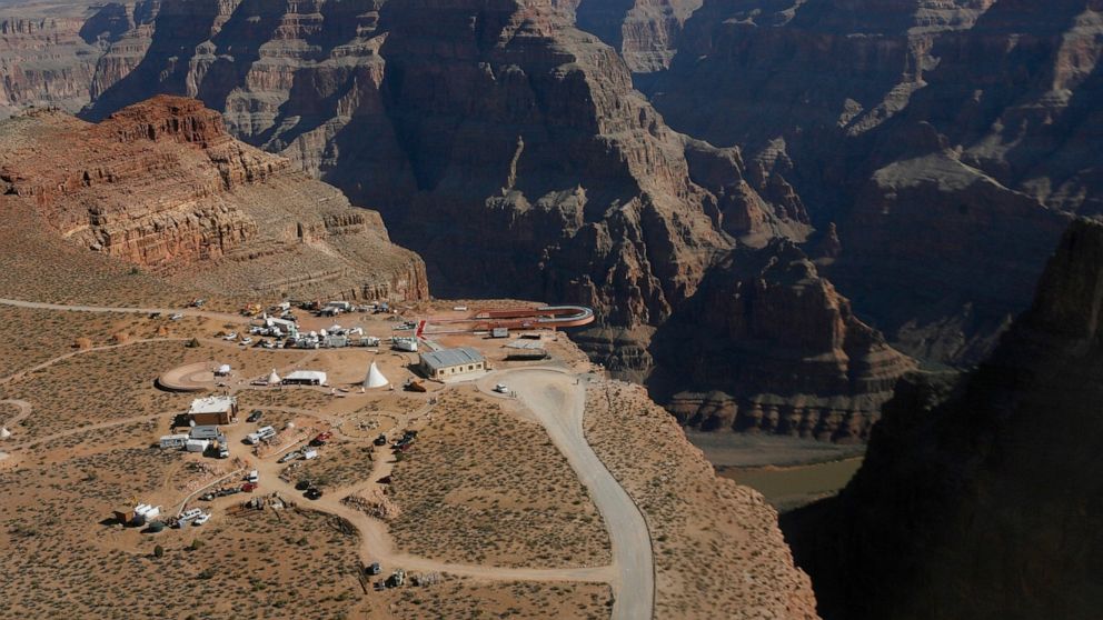 FILE - In this March 20, 2007, file photo, the Skywalk hangs over the Grand Canyon on the Hualapai Indian Reservation before its grand opening ceremony at Grand Canyon West, Ariz. Two recent deaths in which men plummeted to their death in the Grand C