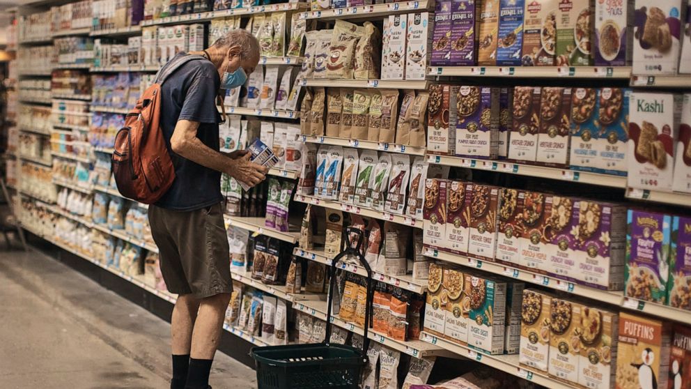 FILE - A man shops at a supermarket on Wednesday, July 27, 2022, in New York. U.S. demand for grocery delivery is cooling as food prices rise. Some shoppers are shifting to less expensive grocery pickup, while others are returning to the store. (AP P