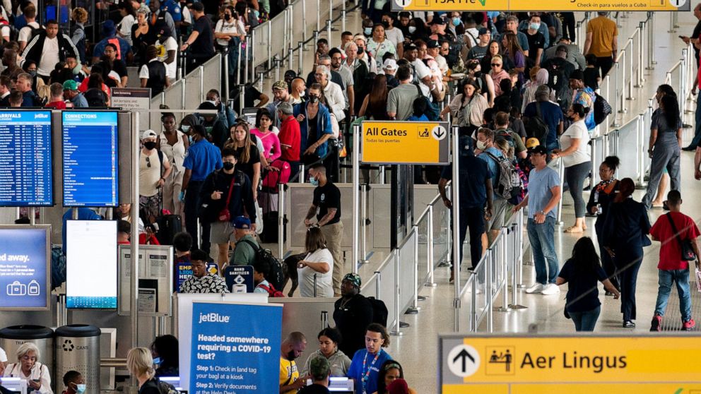 FILE - People wait in a TSA line at the John F. Kennedy International Airport on June 28, 2022, in New York. Tens of thousands of flyers had their travel plans upended Friday, Aug. 5, after airlines canceled more than 1,100 flights for a second strai