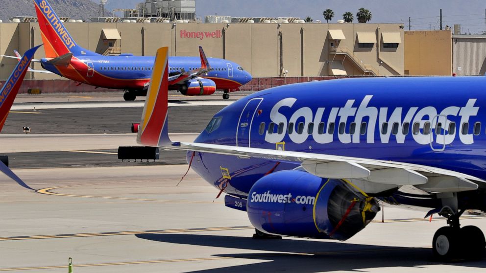 FILE - Southwest Airlines jets are stored at Sky Harbor International Airport in Phoenix, April 28, 2020. Southwest Airlines said Wednesday, Dec. 7, 2022, that it is bringing back dividends for shareholders, which it suspended when the pandemic devas