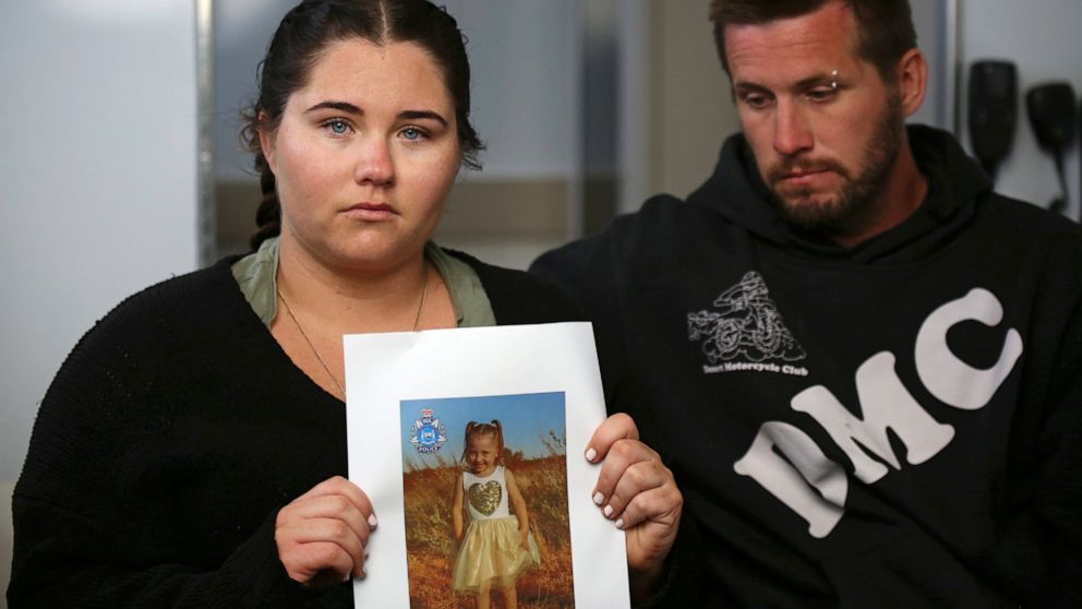 Ellie Smith, left, and her partner Jake Gliddon, display a photo of their missing daughter, Cleo, near Carnarvon in Western Australia state, Australia, Oct. 19, 2021. Cleo was rescued "alive and well" on Wednesday, Nov. 3, 2021, more than three weeks