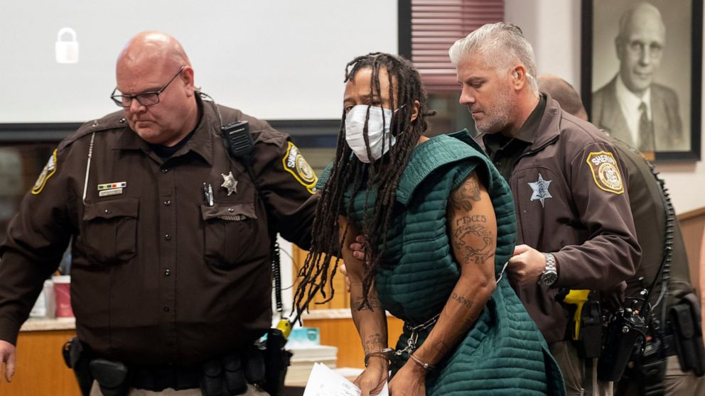 FILE - Darrell Brooks, center, is escorted out of the courtroom after making his initial appearance, Tuesday, Nov. 23, 2021, in Waukesha County Court in Waukesha, Wis. Prosecutors added dozens of charges Wednesday, Jan. 12, 2022, against Brooks, accu
