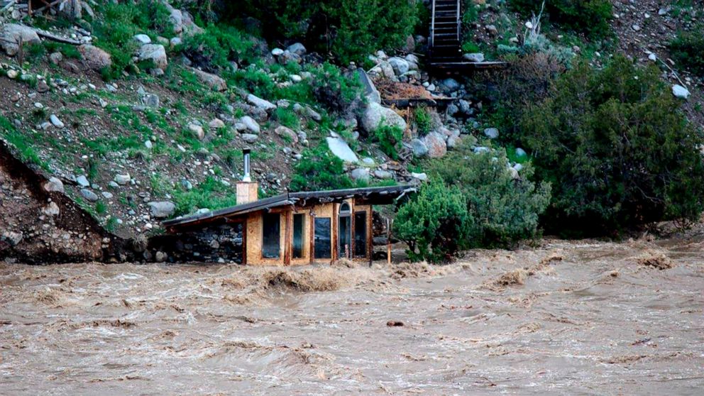 In this photo provided by Sam Glotzbach, the fast-rushing Yellowstone River flooded what appeared to be a small boathouse in Gardiner, Mont., on Monday, June 13, 2022, just north of Yellowstone National Park. (Sam Glotzbach via AP)