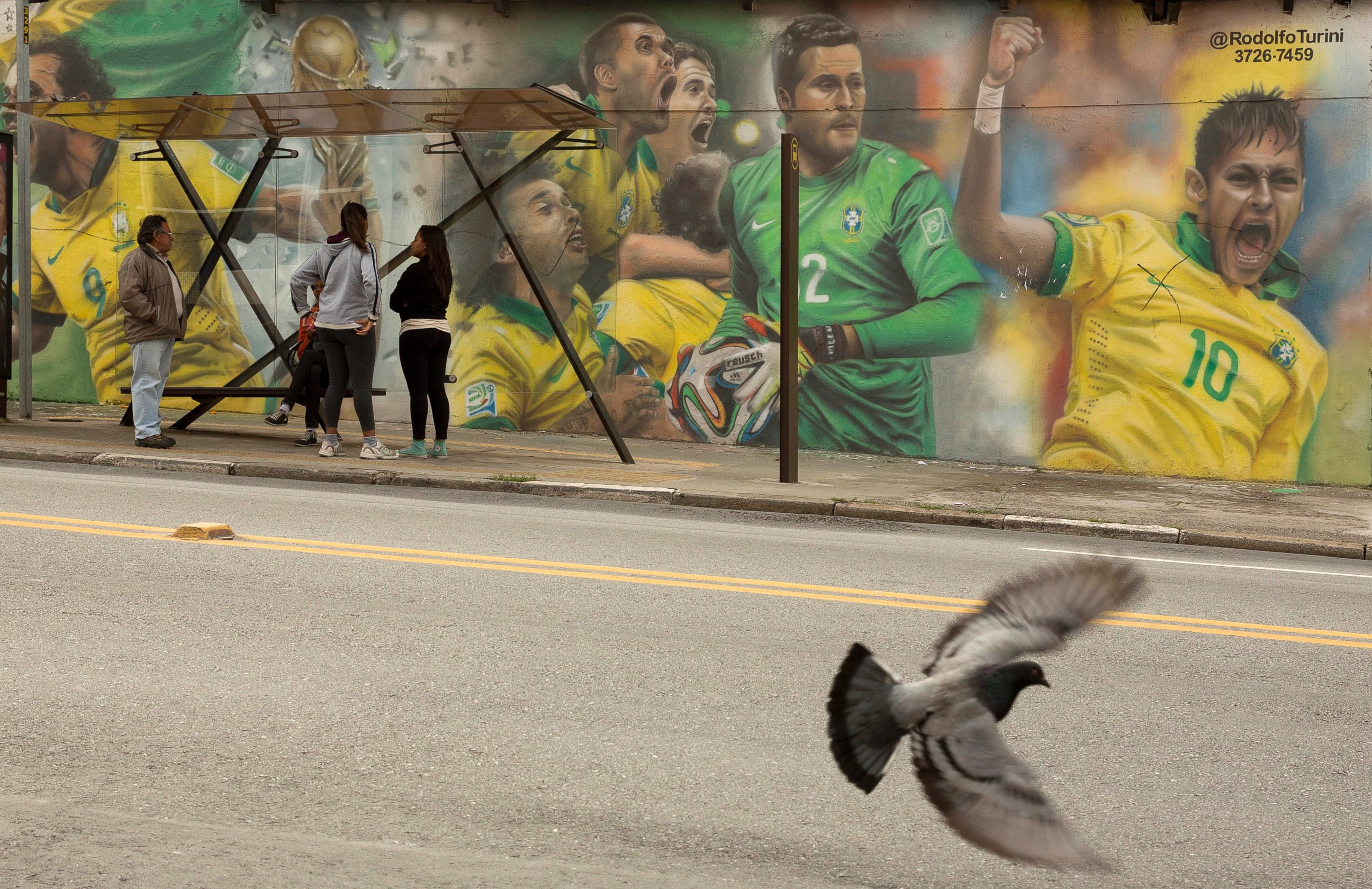 PHOTO: A mural of Brazilian soccer player Neymar, right, and others cover a wall by a bus stop in Sao Paulo, Brazil,  May 26, 2014. 