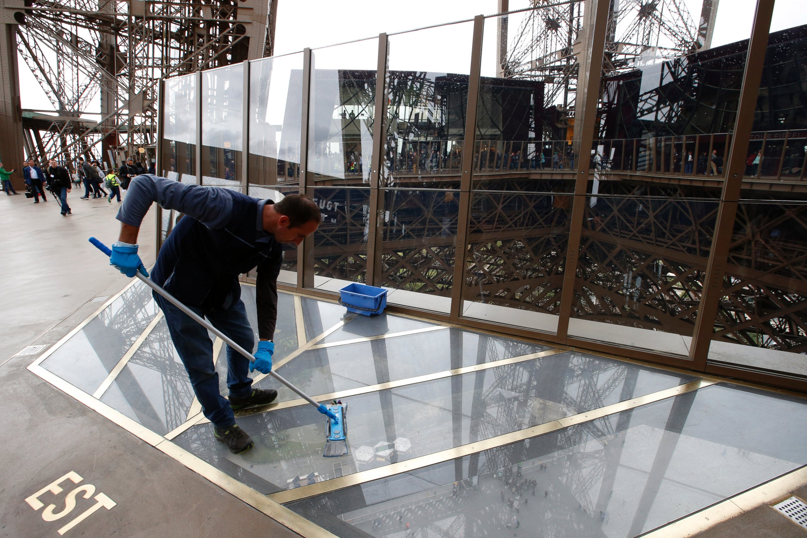 PHOTO: A worker cleans the new glass floor at The Eiffel Tower during the inauguration of the newly refurbished first floor, in Paris, Oct. 6, 2014.