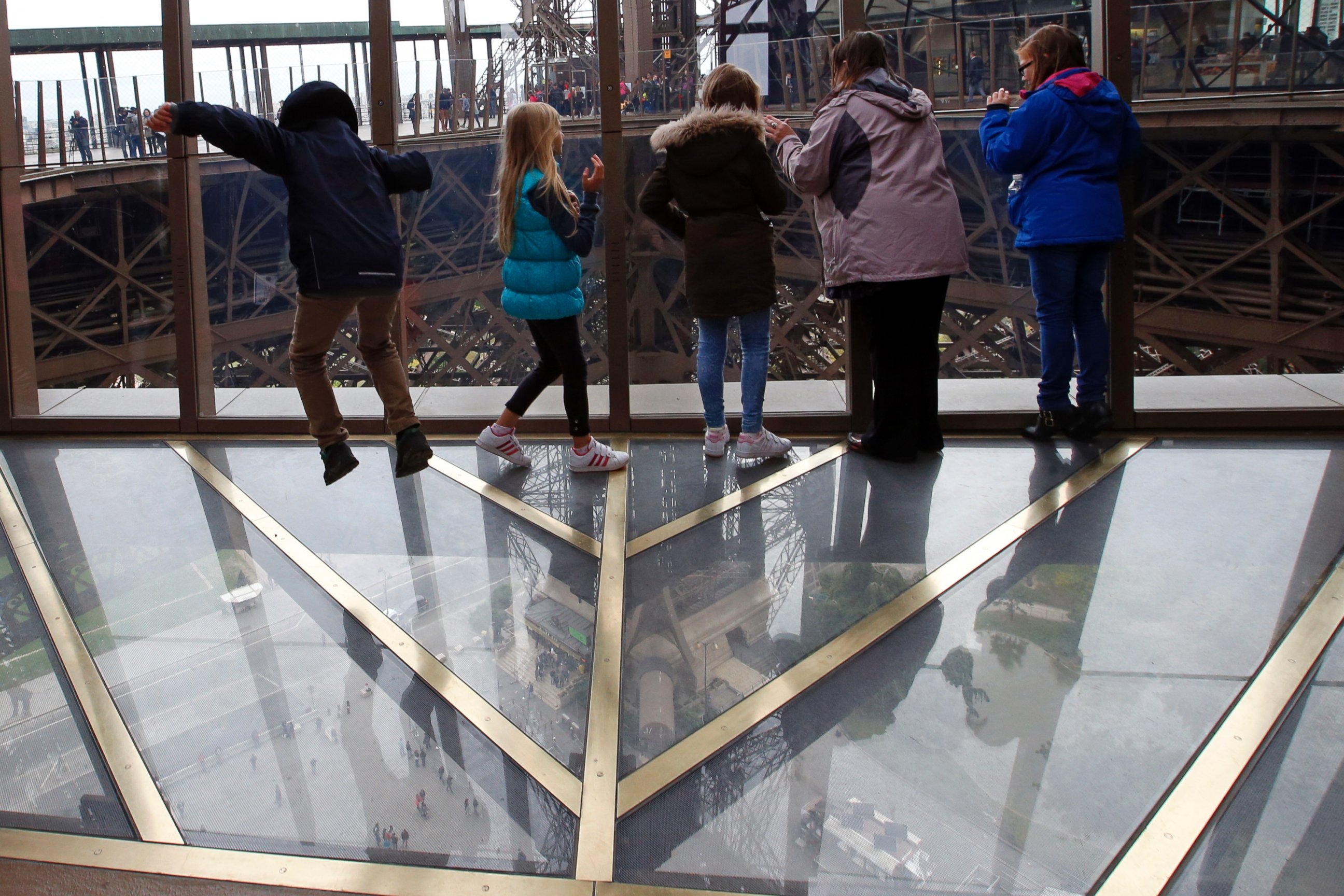 PHOTO: Visitors walk on the new glass floor at The Eiffel Tower during the inauguration of the newly refurbish first floor, in Paris, France, Oct. 6, 2014.
