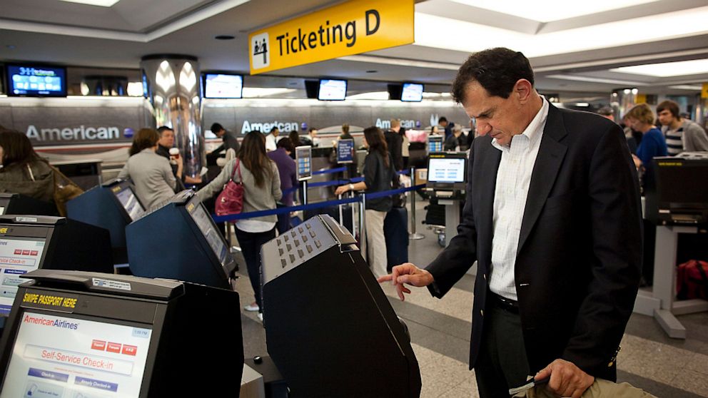 An American Airlines Inc. passenger checks himself in from a self-service check-in kiosk at LaGuardia Airport in the Queens borough of New York, in this April 25, 2011 photo.