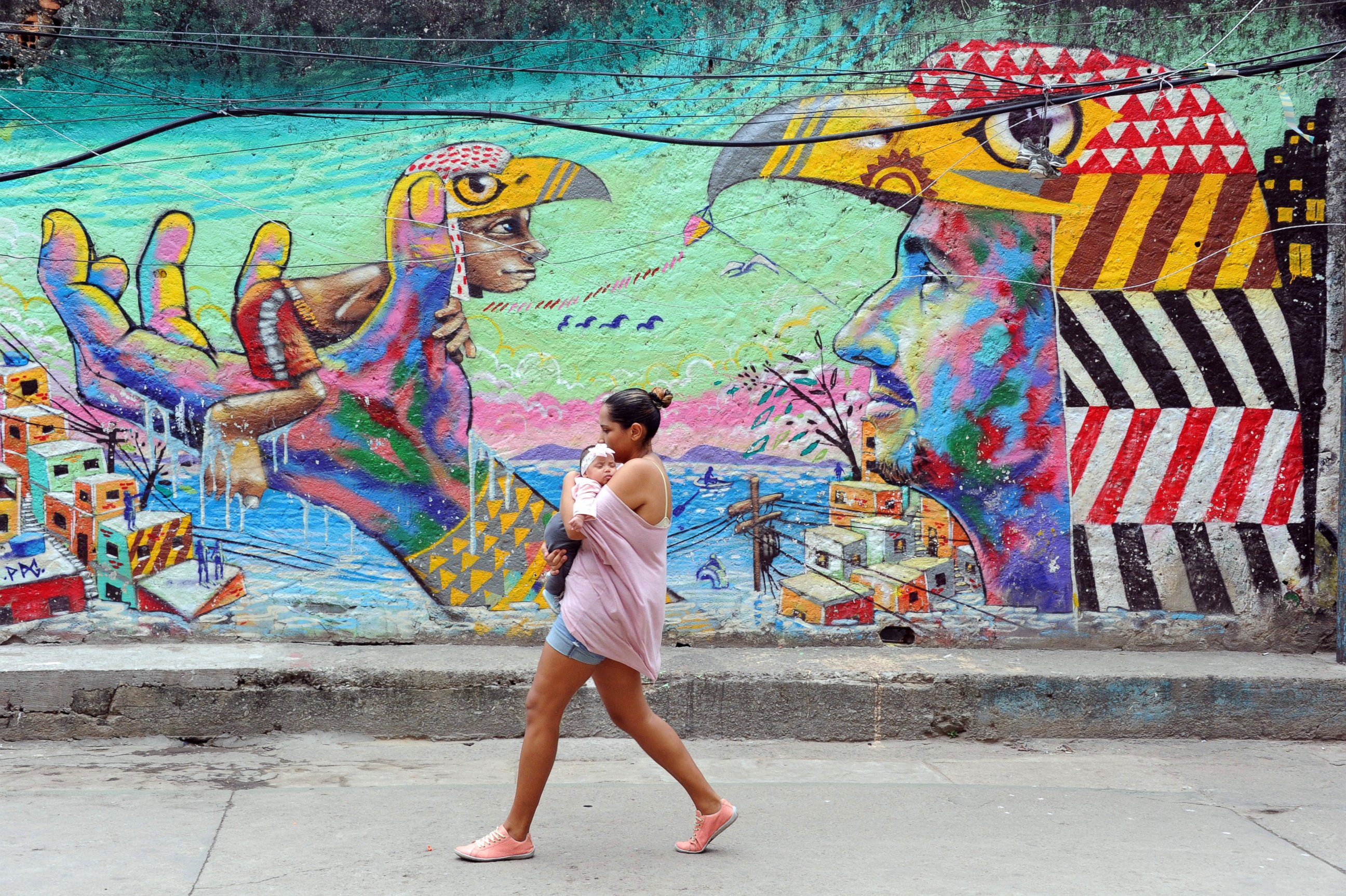 PHOTO: A woman and her baby walk in the streets of the Cantagalo favela, next to Copacabana on April 23, 2014, in Rio de Janeiro.