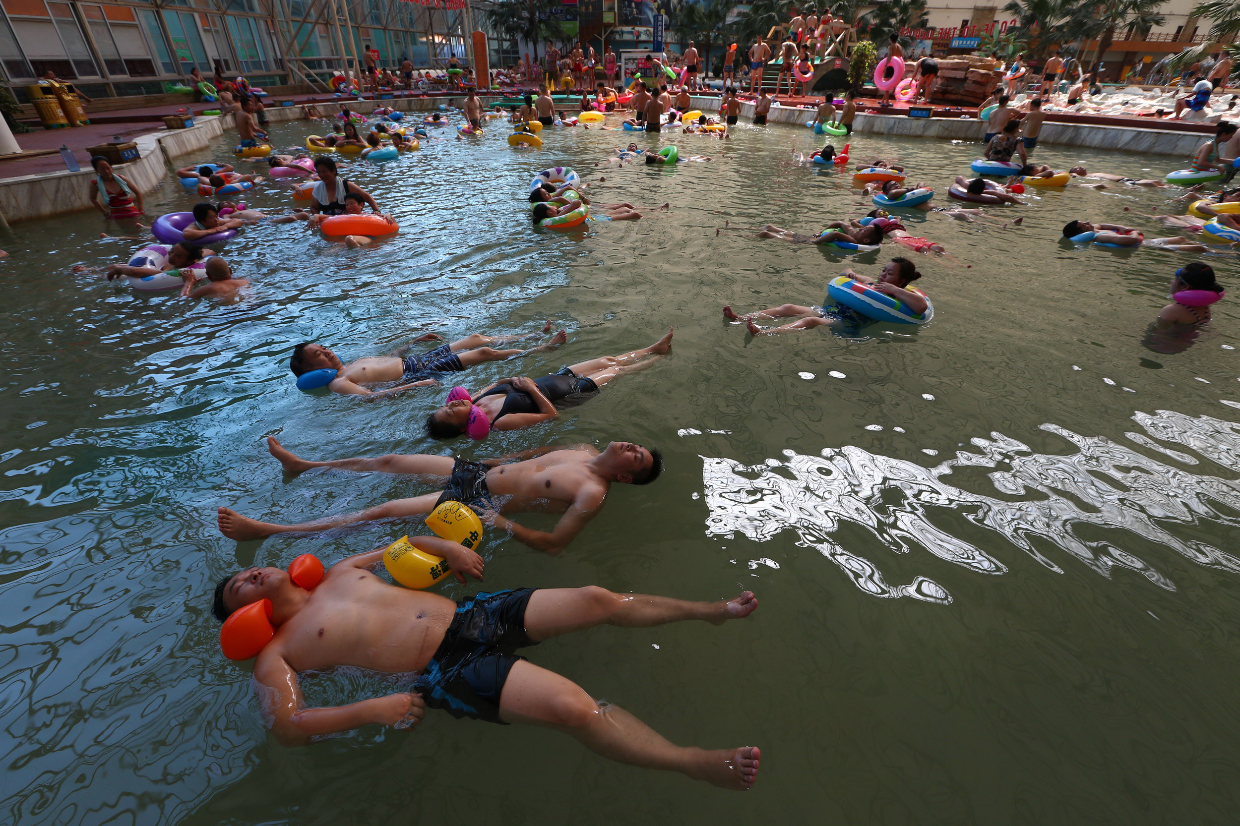 PHOTO: Thousands of people enjoy the water at the Chinese Dead Sea tourist resort as the outside temperatures reached 100 degrees on July 25, 2014 in Suining, China.