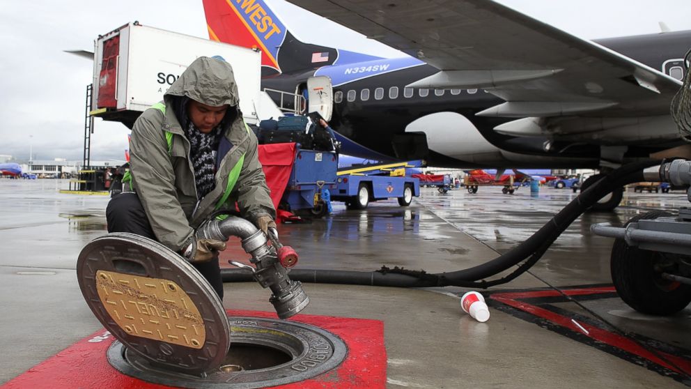 Swissport employee Christopher Gonzalez disconnects a fuel line from an underground fuel tank after he refueled a Southwest Airlines plane at the Oakland International Airport in Oakland, Calif., Feb. 24, 2011.