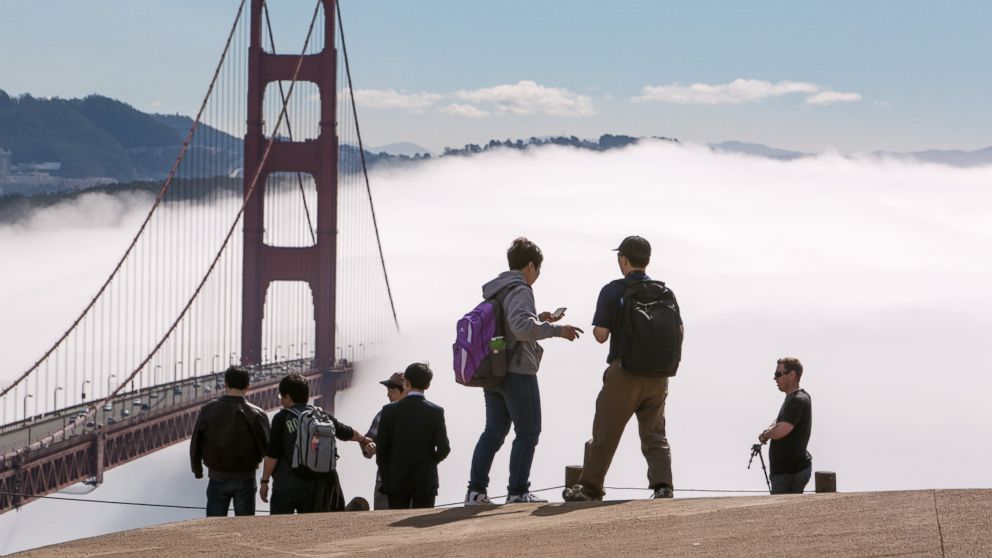 A group of tourists take photographs at the Golden Gate Bridge on Feb. 13, 2014, in San Francisco, Calif.