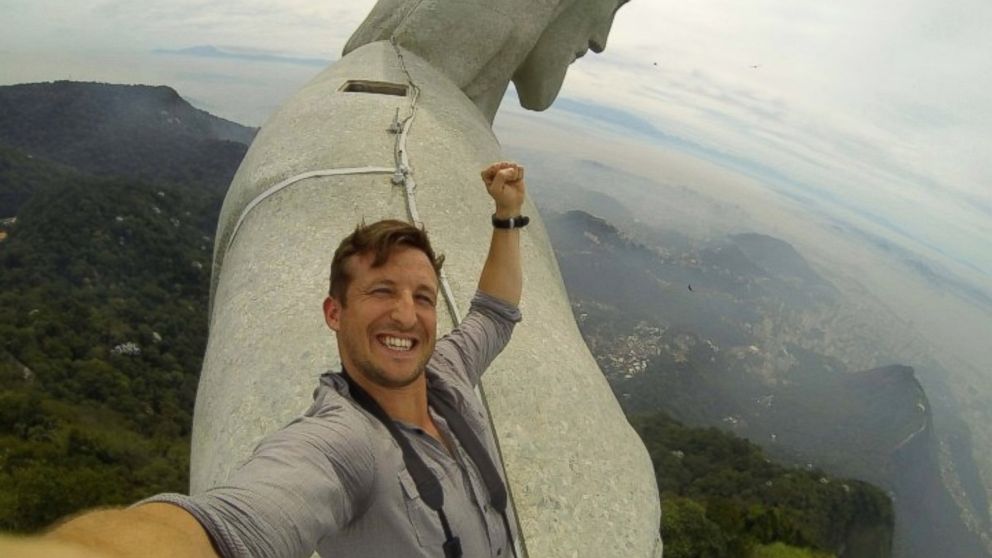 Lee Thompson of the travel company The Flash Pack is seen on top of the Christ the Redeemer statue in Rio de Janeiro. 