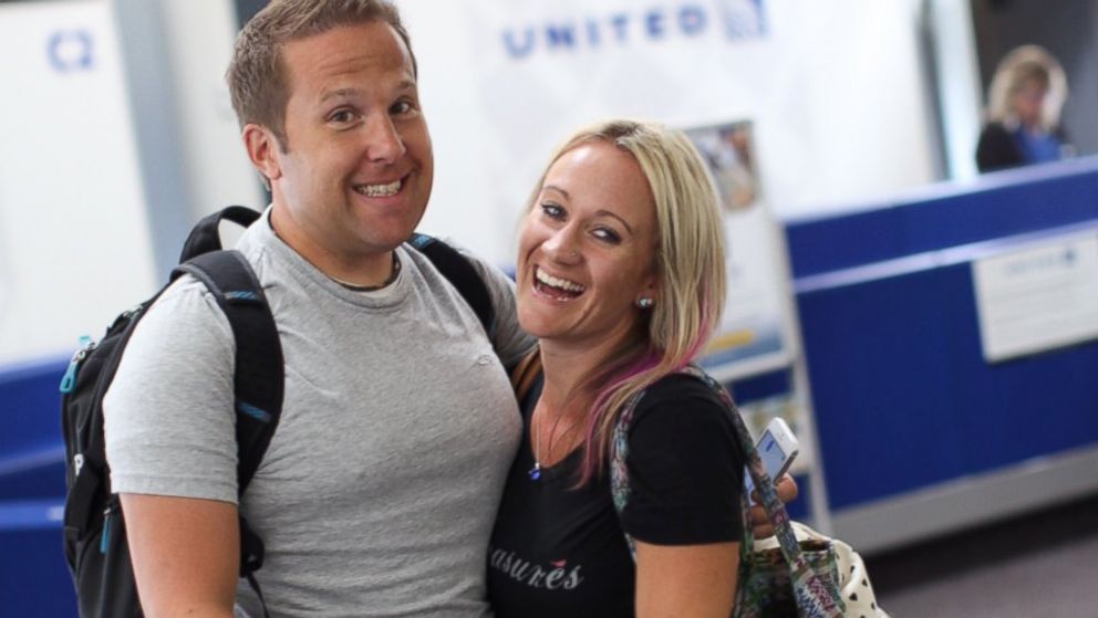 PHOTO: Sarah Lynn and David Olson are all smiles when they arrive at the airport en route to meeting their daughter, Tilly. 
