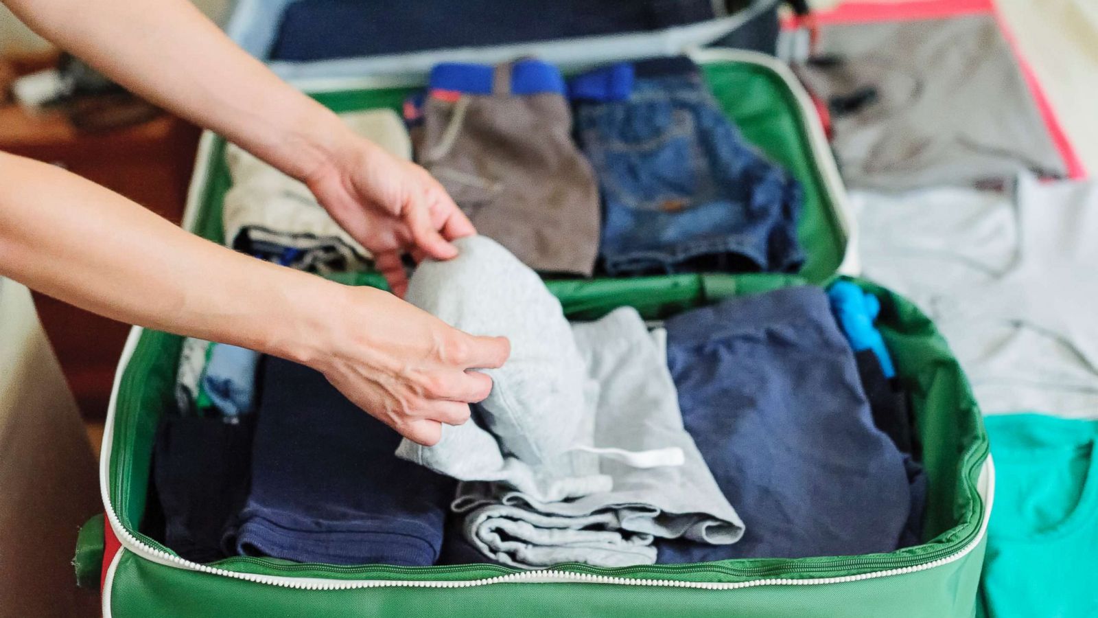 PHOTO: A person is seen packing a suitcase on the bed in this undated stock photo.