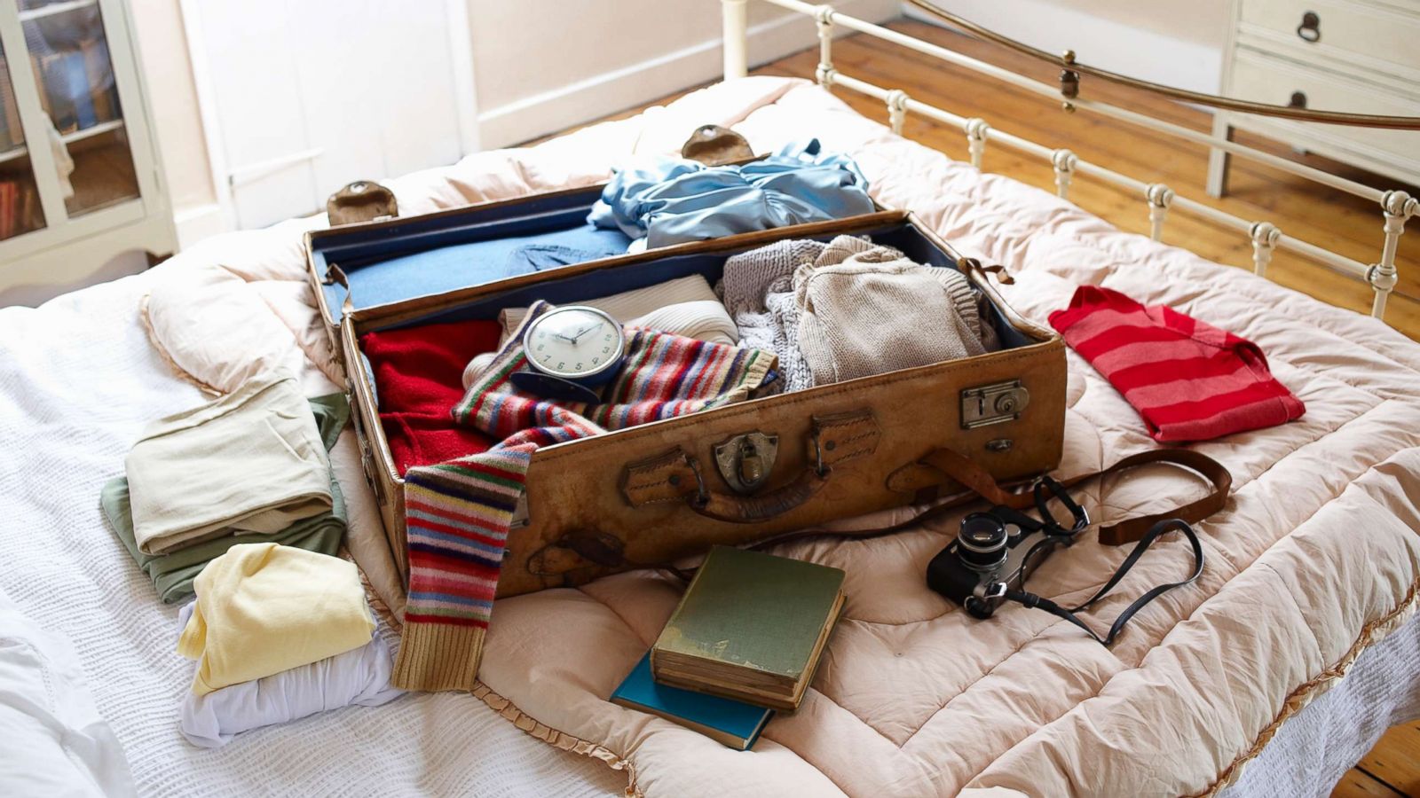 PHOTO: Items in a suitcase on a bed are pictured in this undated stock photo.