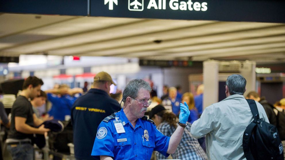 A TSA agent instructs travelers on traveling through security lines at Pittsburgh International Airport, Nov. 24, 2010.