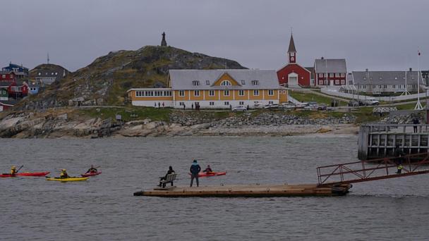 Tourists kayak at sea in front of Nuuk Cathedral in Nuuk, Greenland, Monday, June 16, 2025. (AP Photo/Kwiyeon Ha)
