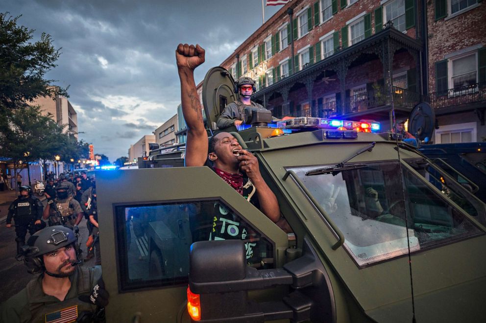 PHOTO: Kendrick Cutkelvin of Savannah uses a Savannah SWAT vehicle loudspeaker to disperse a small crowd of protesters after a peaceful rally and march in honor of George Floyd, May 31, 2020, in Savannah, Ga.