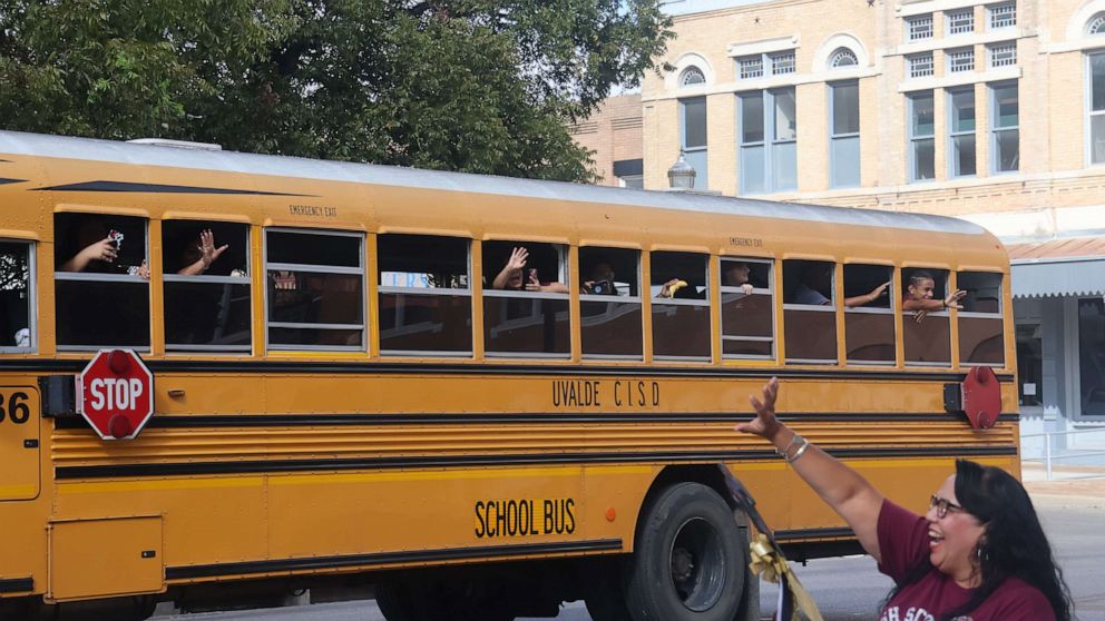 PHOTO: A woman waves at a bus in downtown Uvalde, Texas, on Oct. 14, 2022. Daniel's older brother John was going to a band competition in San Antonio and people gathered to wish the team luck and show their support.
