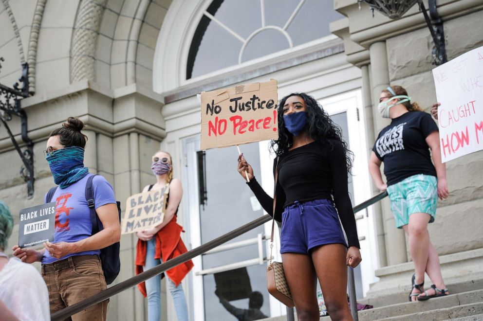PHOTO: Protesters stand on the steps of the City-County Building in Helena, Mont., May 29, 2020, in solidarity with nationwide protests over the death of George Floyd in Minneapolis police custody on May 25.