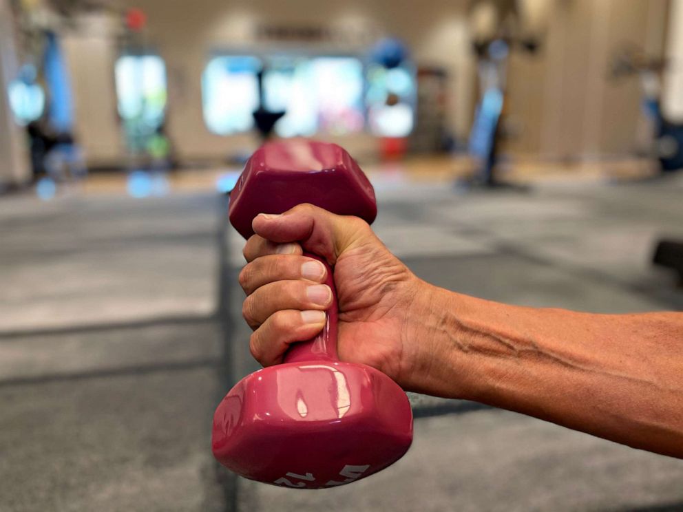 PHOTO: On days Seidholz has energy he lifts small hand weights. He could lift 100 lb weights before getting COVID-19.