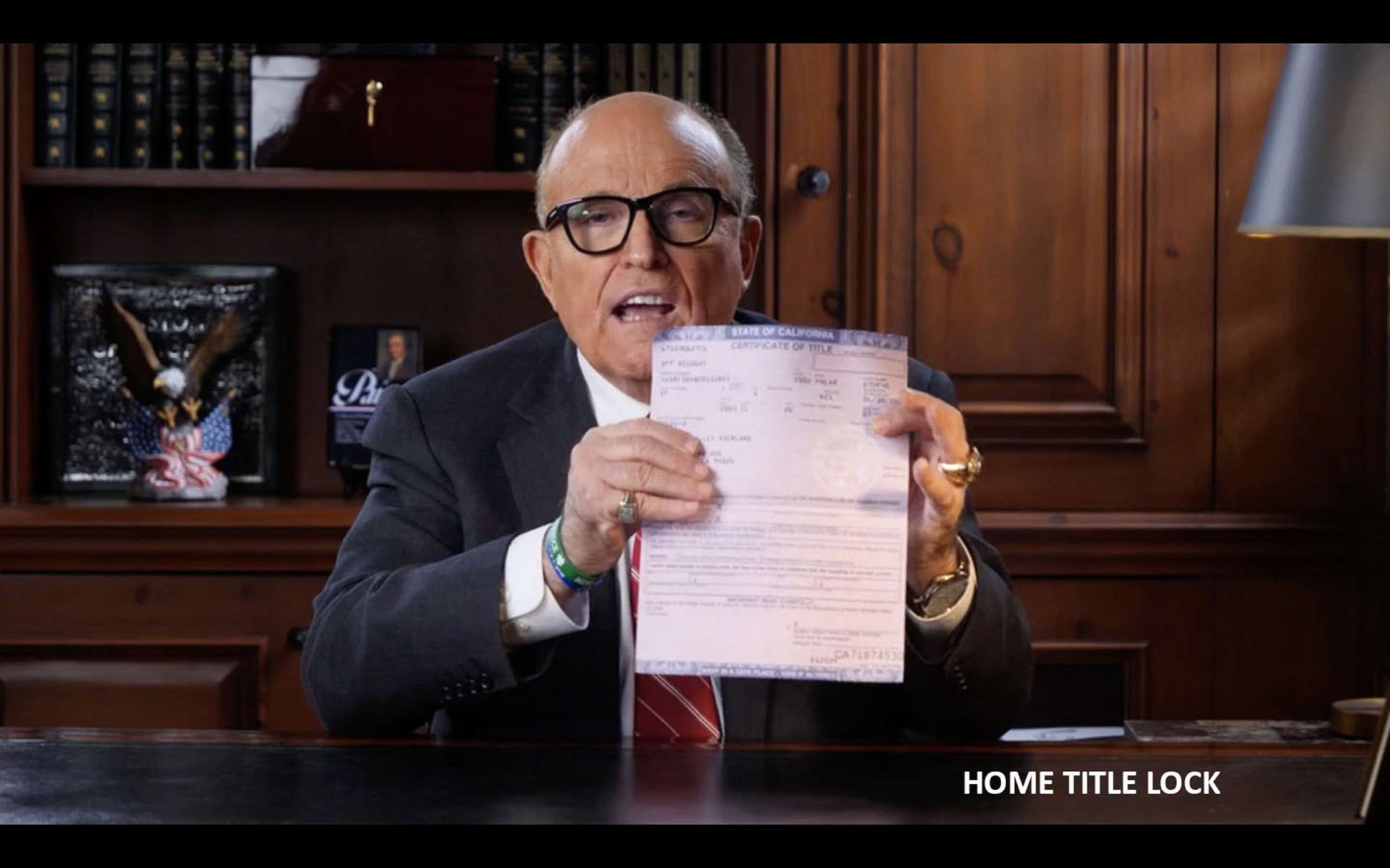 PHOTO: In an ad for Home Title Lock, Rudy Giuliani holds up what he describes as "a legal title to a home in California."