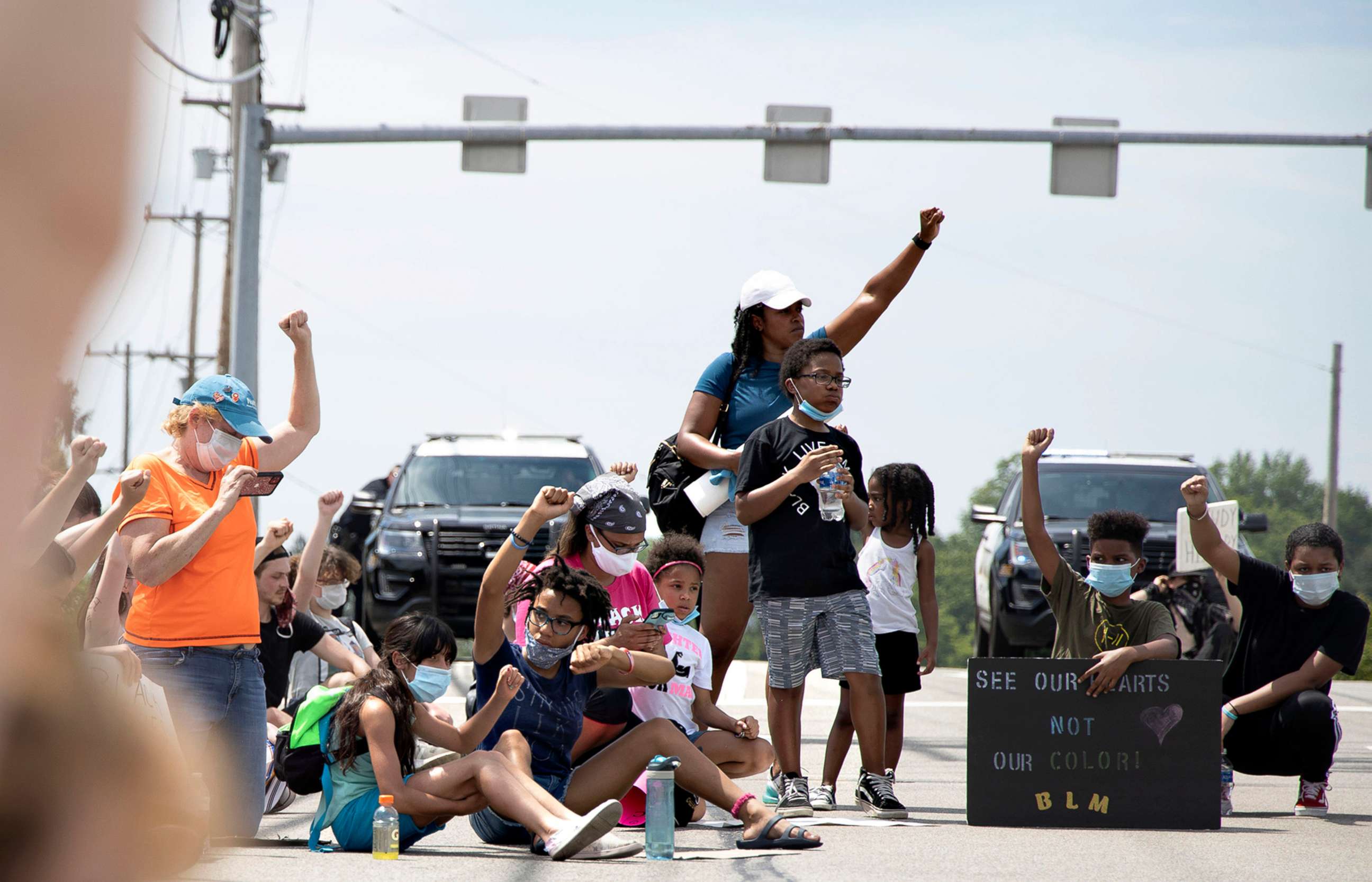 PHOTO:Protesters sit with their arms raised for 8 minutes, 46 seconds, honoring George Floyd, at an intersection, June 9, 2020, in Monroeville, Pa. The peaceful protest was organized by 16-year-old Elena Alarcon, of Turtle Creek.