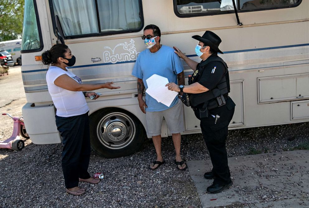 PHOTO: Maricopa County constable Darlene Martinez brokers a deal between delinquent renter Hector Medrano and property manager Teodora Carcia at an RV park on Oct. 07, 2020, in Phoenix.