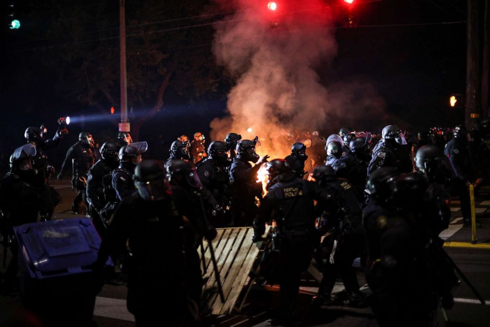 PHOTO: Police advance on protesters to clear a street on the 100th consecutive night of protests against police violence and racial inequality, in Portland, Oregon, on Sept. 5, 2020.