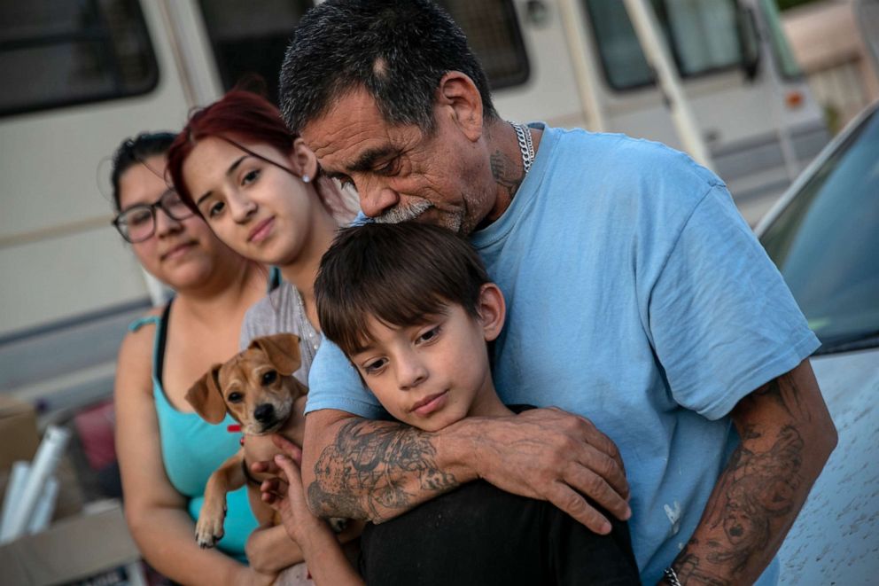 PHOTO: The Medrano family sit outside their RV on Oct. 07, 2020, in Phoenix. They narrowly avoided eviction from the RV park earlier in the day.