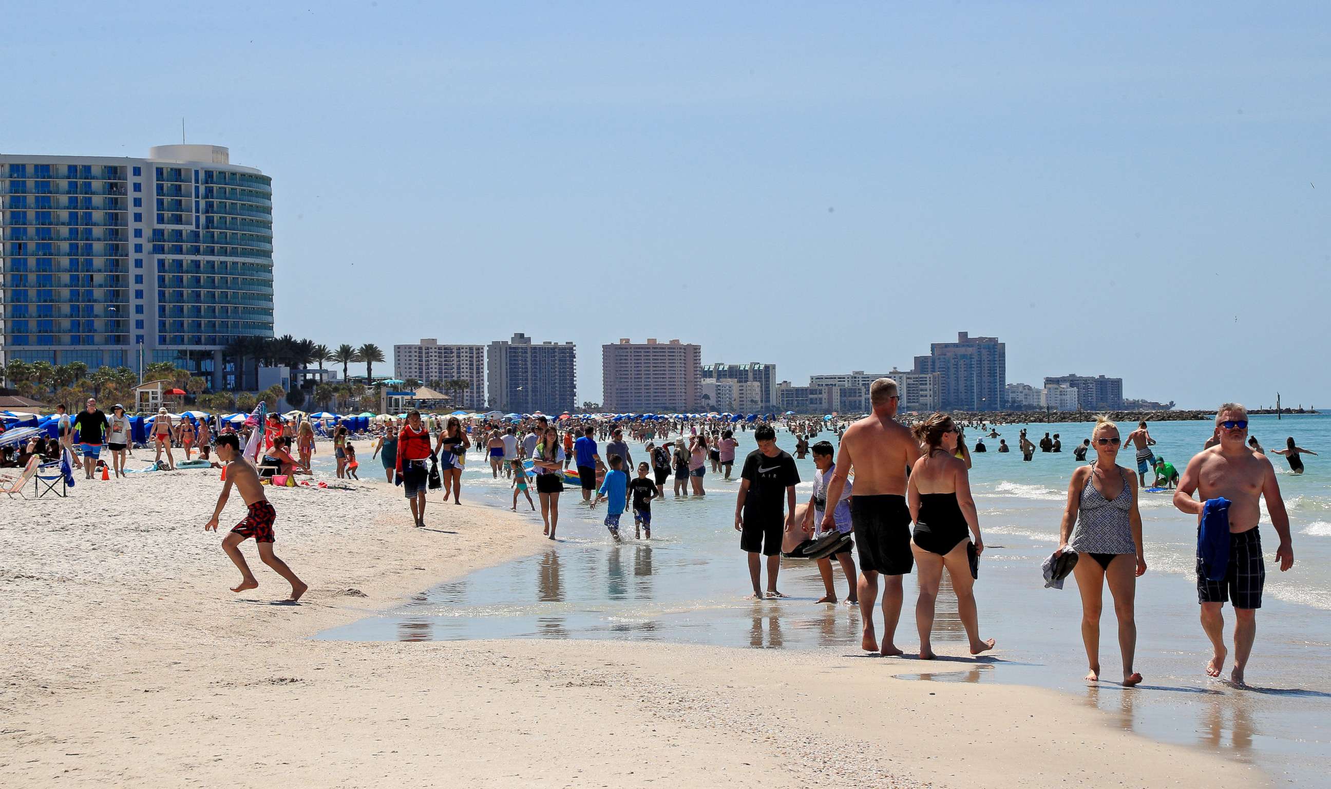 PHOTO: CLEARWATER, FL - MARCH 18:  People gather on Clearwater Beach during spring break despite world health officials' warnings to avoid large groups on March 18, 2020 in Clearwater, Florida.